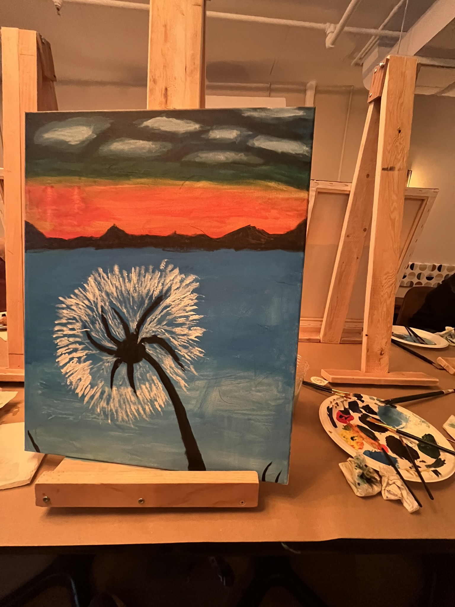 My first painting: a dandelion against a sunset over still water